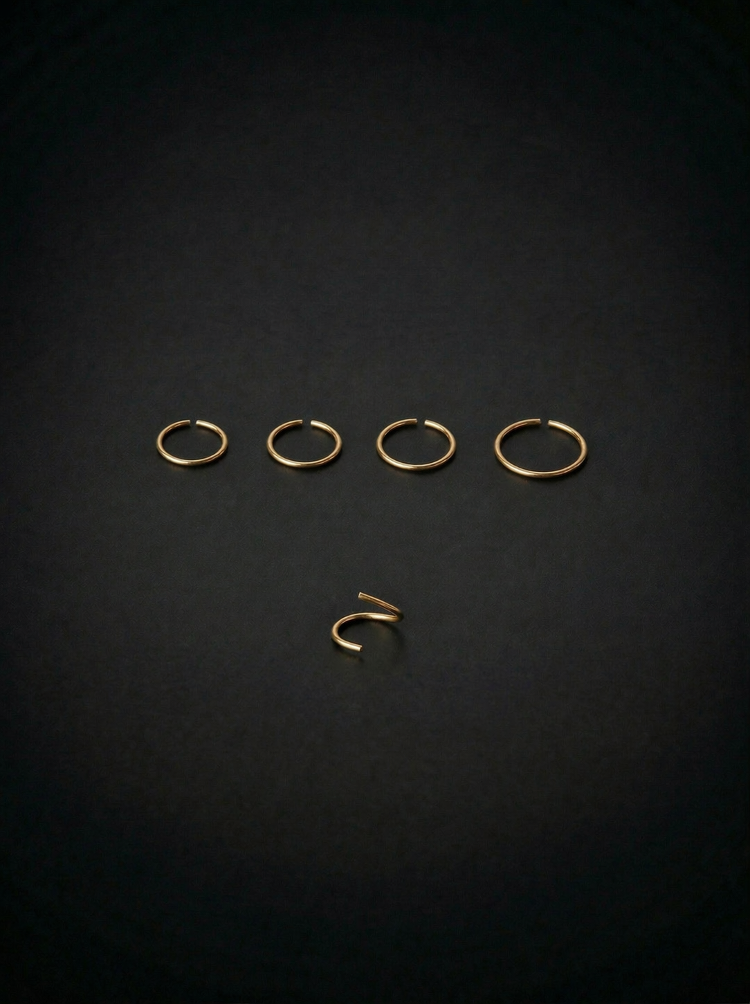 Set of gold earrings on a black background