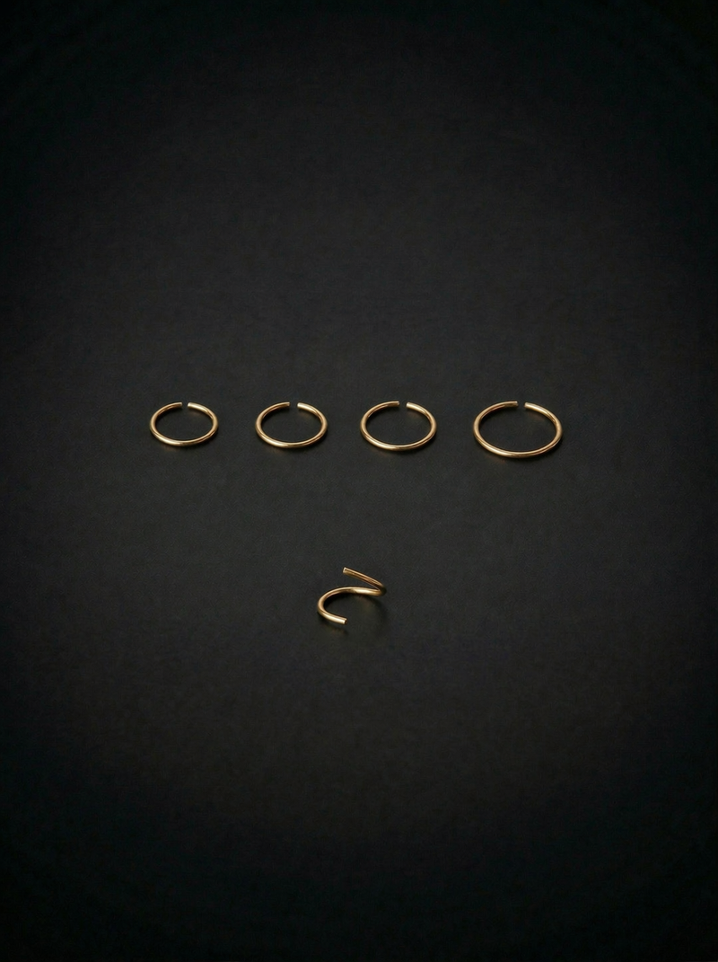 Set of gold earrings on a black background