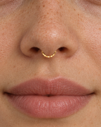 A delicate 14ct solid gold seamless septum hoop with a hand-hammered lower half. Choose 16G or 18G in yellow, white or rose gold. Handmade to order.