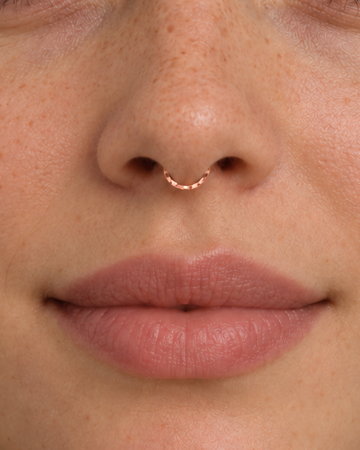 A delicate 14ct solid gold seamless septum hoop with a hand-hammered lower half. Choose 16G or 18G in yellow, white or rose gold. Handmade to order.