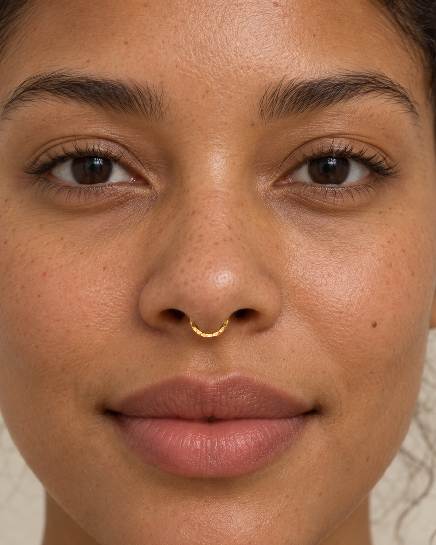 A delicate 14ct solid gold seamless septum hoop with a hand-hammered lower half. Choose 16G or 18G in yellow, white or rose gold. Handmade to order.