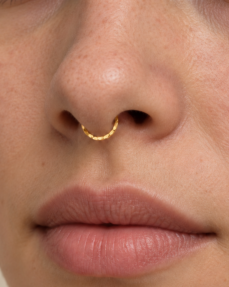 A delicate 14ct solid gold seamless septum hoop with a hand-hammered lower half. Choose 16G or 18G in yellow, white or rose gold. Handmade to order.