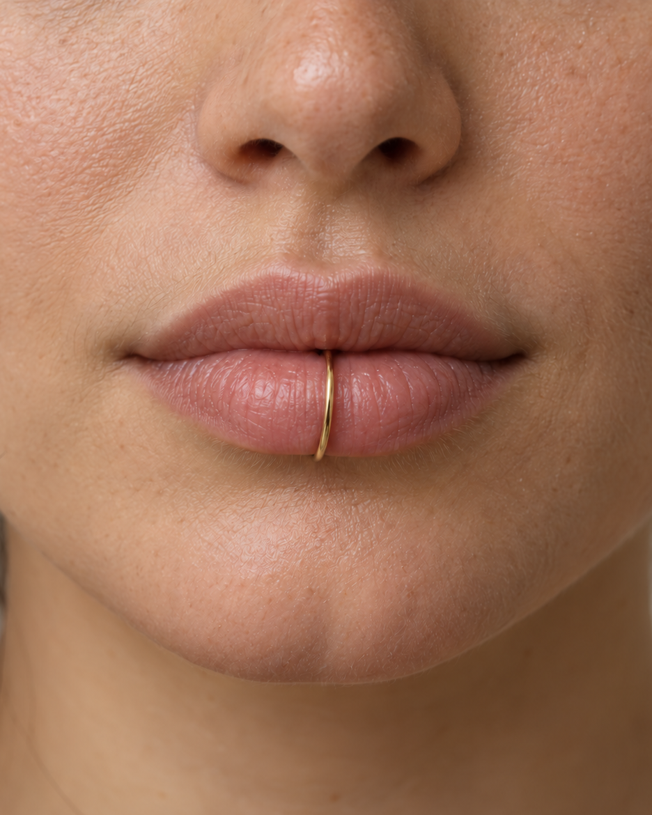 A lightweight 14ct solid gold seamless hoop for healed lobe piercings. Handmade to order, nickel-free and suitable for comfortable everyday wear.
