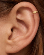 A little reminder of a favourite companion. This 14ct solid gold dog helix ring pairs an approximately 3mm polished puppy-face silhouette with a smooth seamless hoop. Its rounded face and floppy ears add a playful detail to your ear stack, with no engraved features or gemstones.