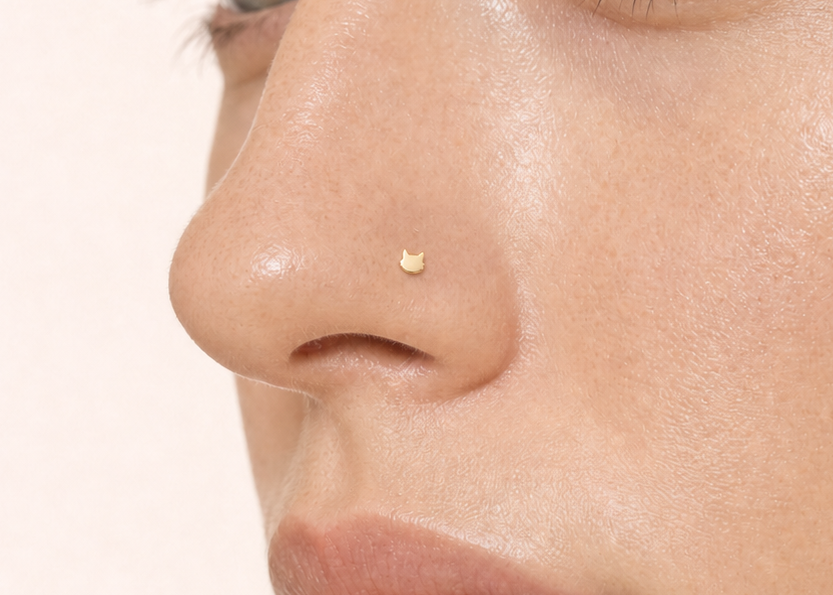 A playful 14ct solid gold Cat Hoop with a minimalist cat head, pointed ears and rounded cheeks. Available in 18G or 20G and 6–10mm.