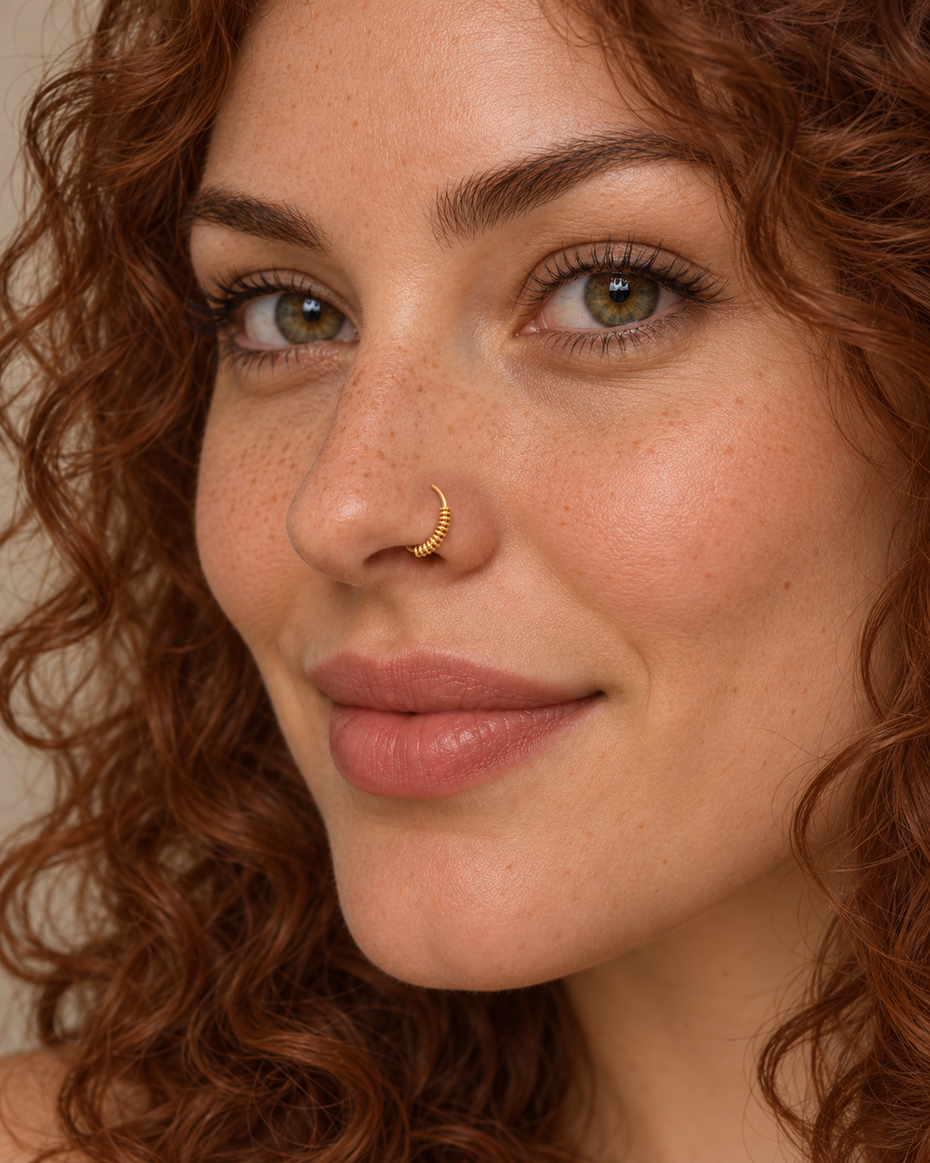 A little detail for your everyday nose ring. Solis brings a softly wrapped lower curve to a delicate 14ct solid gold nostril ring. Fine gold wire is wound by hand around approximately half the hoop, while the upper arc stays smooth and polished.