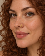A little detail for your everyday nose ring. Solis brings a softly wrapped lower curve to a delicate 14ct solid gold nostril ring. Fine gold wire is wound by hand around approximately half the hoop, while the upper arc stays smooth and polished.