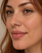 A little detail for your everyday nose ring. Solis brings a softly wrapped lower curve to a delicate 14ct solid gold nostril ring. Fine gold wire is wound by hand around approximately half the hoop, while the upper arc stays smooth and polished.