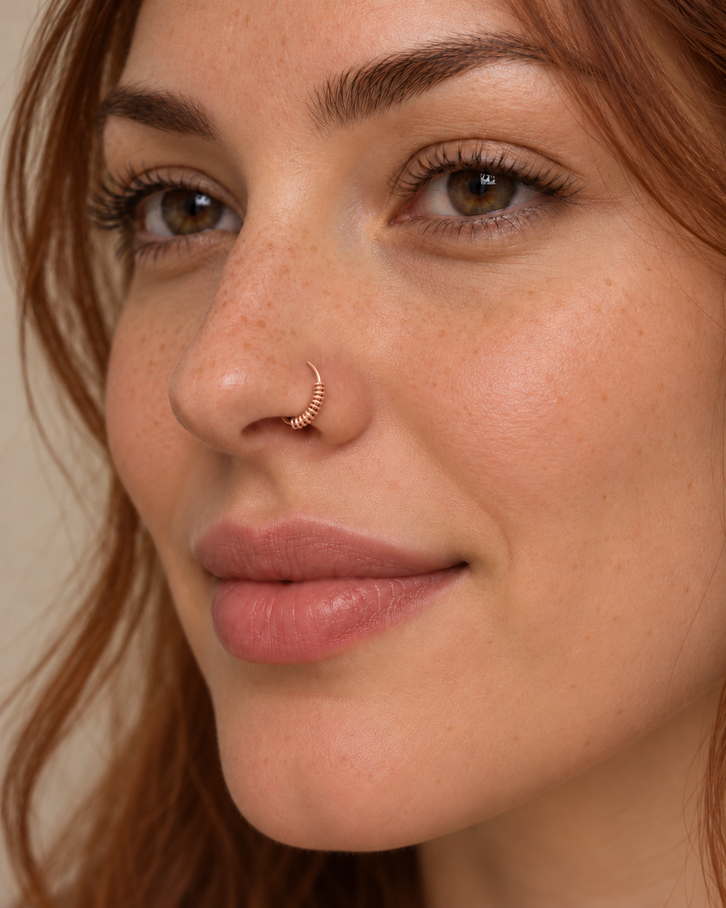 A little detail for your everyday nose ring. Solis brings a softly wrapped lower curve to a delicate 14ct solid gold nostril ring. Fine gold wire is wound by hand around approximately half the hoop, while the upper arc stays smooth and polished.