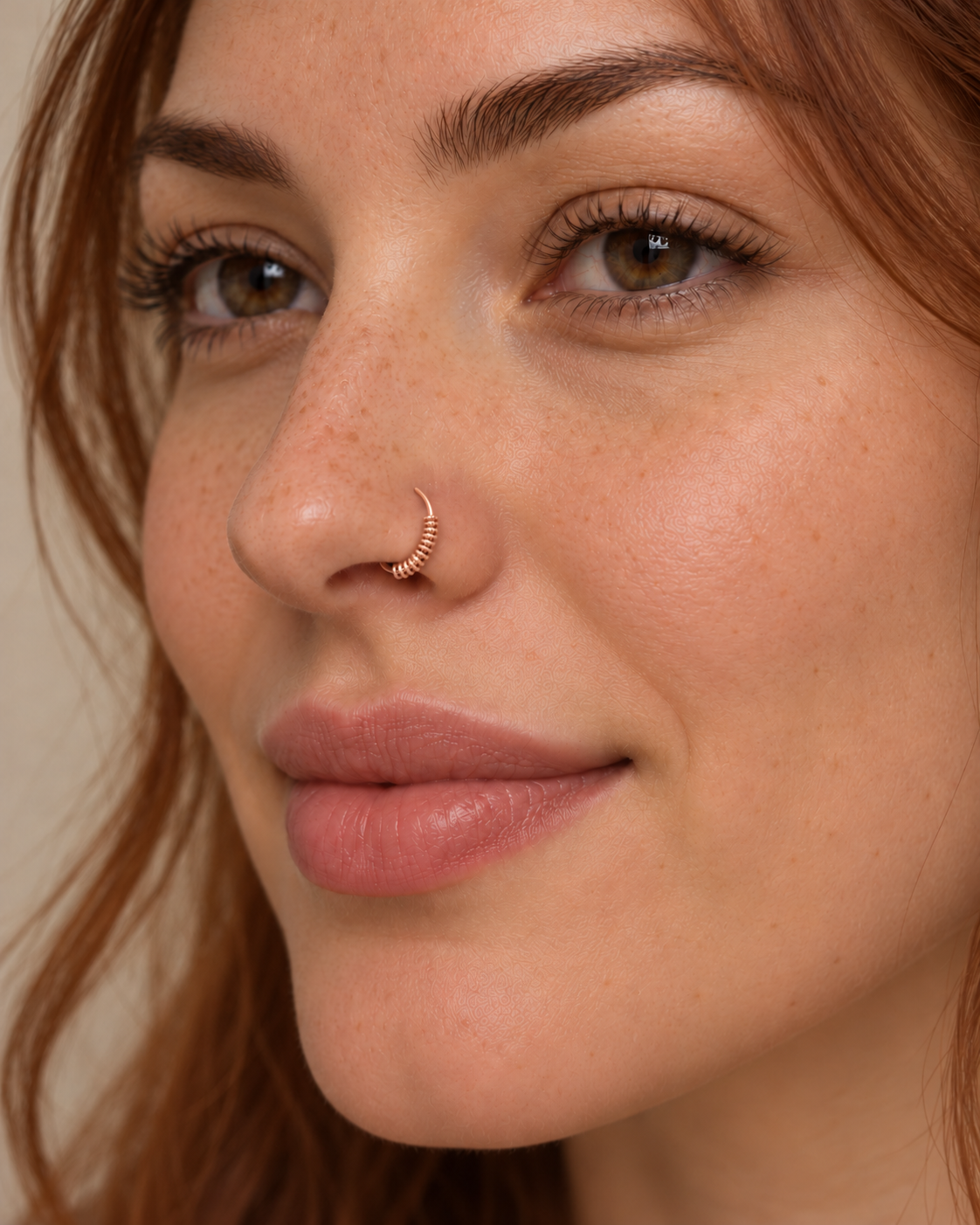 A little detail for your everyday nose ring. Solis brings a softly wrapped lower curve to a delicate 14ct solid gold nostril ring. Fine gold wire is wound by hand around approximately half the hoop, while the upper arc stays smooth and polished.