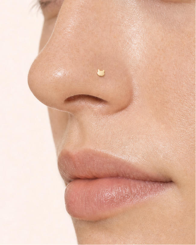 A playful 14ct solid gold Cat Hoop with a minimalist cat head, pointed ears and rounded cheeks. Available in 18G or 20G and 6–10mm.