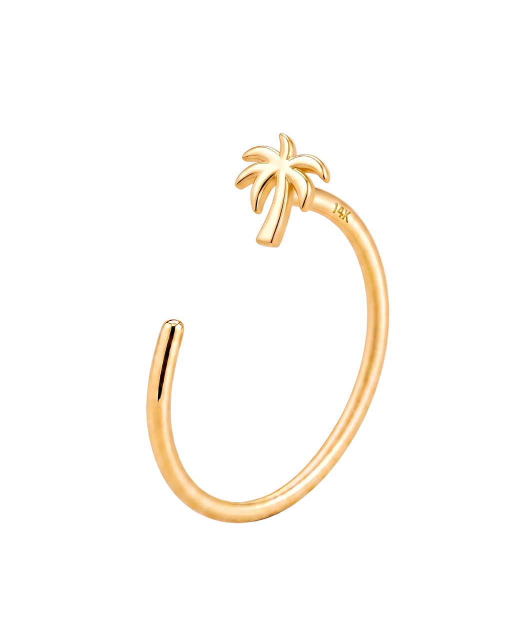A gold open-ended  nose ring featuring a small palm tree charm at the top, photographed on a clean, light cream background.