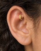 A small coffin motif gives the hoop a compact gothic accent with a clean polished finish. Made for fully healed traditional rook piercings, it gives a small curved ear placement a clear motif-led detail while keeping the hoop clean and wearable. Handmade to order in 14ct solid gold, it fits naturally with gothic, alternative and Halloween-led styling rather than reading as a generic plain hoop.