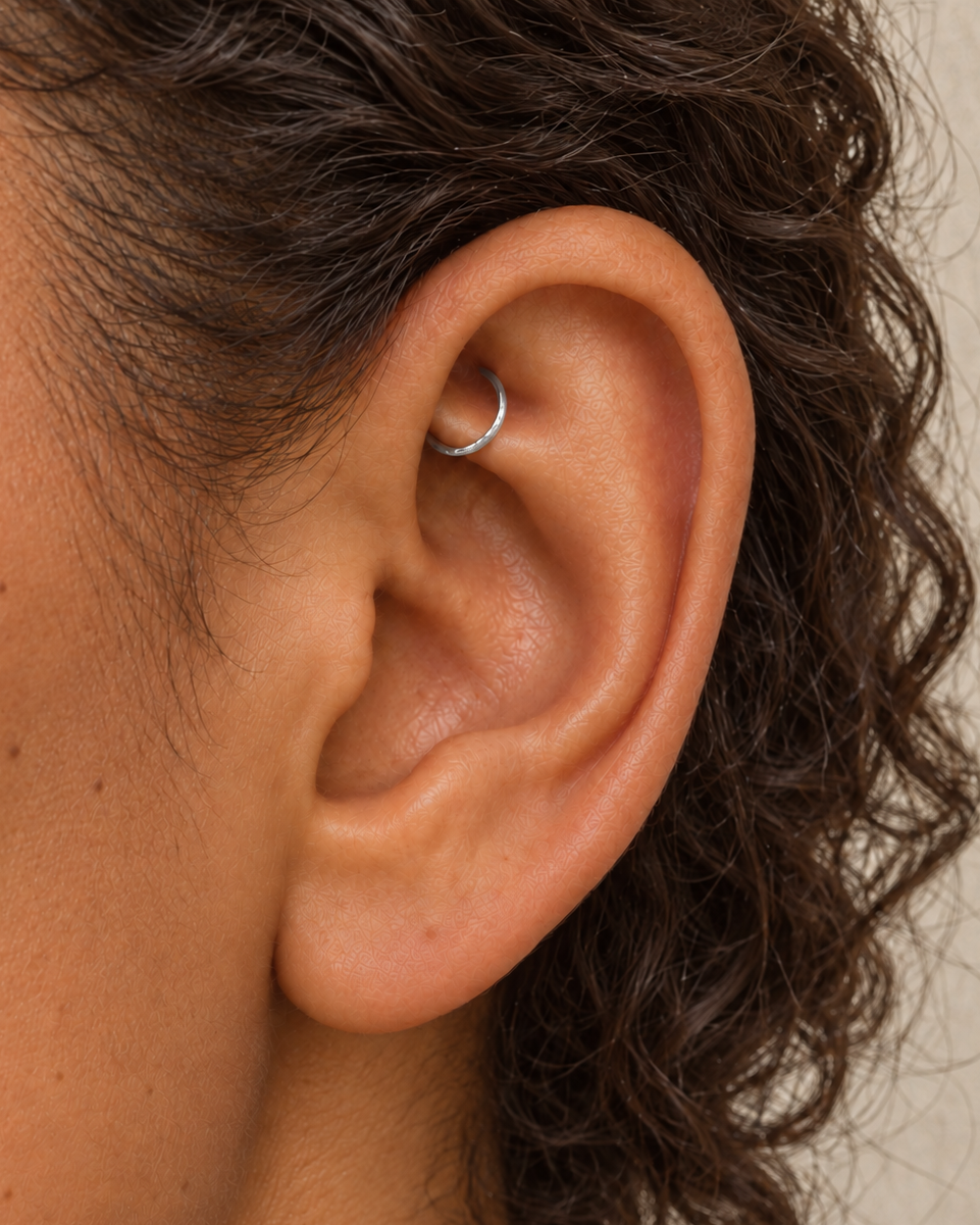Handmade 14ct solid gold rook hoop with unique hammer marks. Choose 4–8mm, 16G, 18G or 20G, in yellow, white or rose gold for your fully healed rook piercing.
