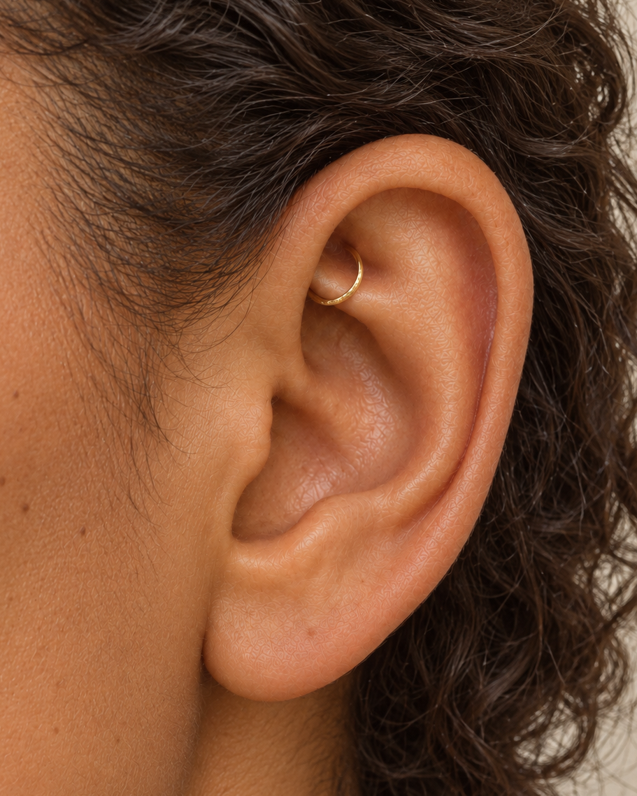 Handmade 14ct solid gold rook hoop with unique hammer marks. Choose 4–8mm, 16G, 18G or 20G, in yellow, white or rose gold for your fully healed rook piercing.
