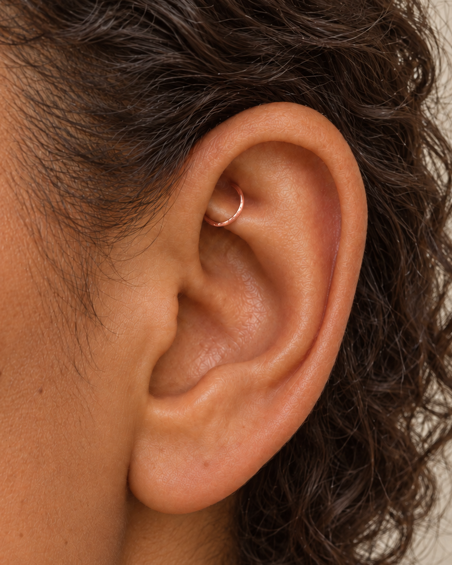 Handmade 14ct solid gold rook hoop with unique hammer marks. Choose 4–8mm, 16G, 18G or 20G, in yellow, white or rose gold for your fully healed rook piercing.