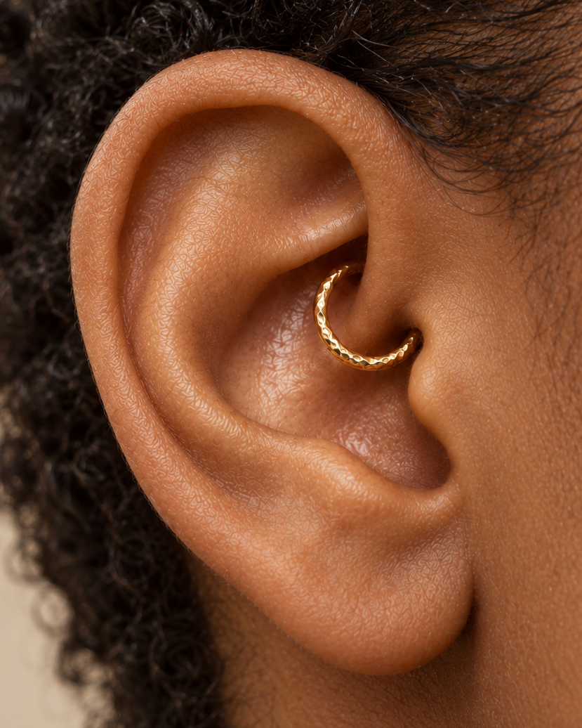 A little glimmer within your ear. Discover a 14ct solid gold daith ring with a unique hand-hammered texture, handmade to order in yellow, white or rose gold.