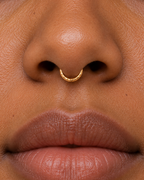 Discover Glimmer, a 14ct solid gold septum ring with a unique hand-hammered texture. Handmade to order in yellow, white or rose gold, with your choice of fit.