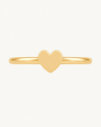 A softly rounded heart adds a sweet, personal detail to a simple gold hoop. Made for fully healed helix piercings, it keeps the profile compact for an upper-ear stack while leaving the motif clearly visible. Handmade to order in 14ct solid gold, it fits naturally with soft, personal and romantic styling rather than reading as a generic plain hoop.