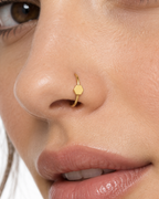 A small triangle gives the hoop a sharper geometric detail with a clean modern feel. Made for fully healed nostril piercings, the motif sits directly on a clean round hoop so the look stays neat rather than dangly. Handmade to order in 14ct solid gold, it fits naturally with clean, geometric and modern styling rather than reading as a generic plain hoop.