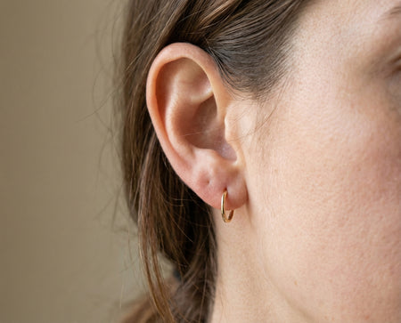 Lobe Piercing piercing with 14K solid gold hoop ring