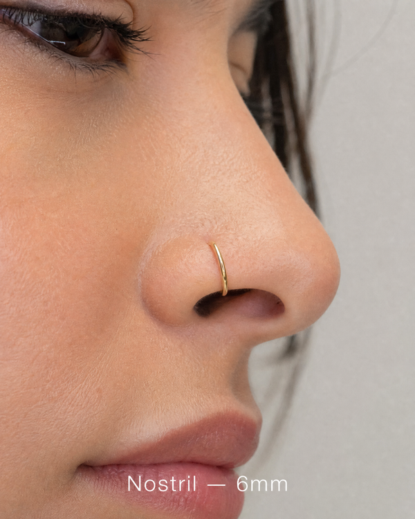 6mm 14K gold seamless nostril ring on nose