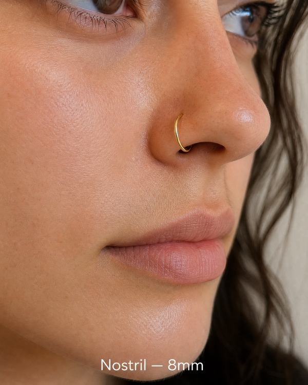 8mm 14K gold seamless nostril ring on nose