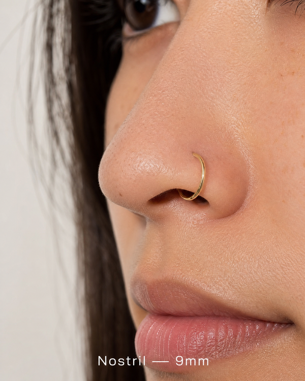 9mm 14K gold seamless nostril ring on nose
