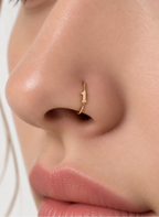 Choose one digit to give the hoop a small number-led detail with personal meaning. Made for fully healed nostril piercings, the motif sits directly on a clean round hoop so the look stays neat rather than dangly. Handmade to order in 14ct solid gold, it fits naturally with personalised, number-led and meaningful styling rather than reading as a generic plain hoop.