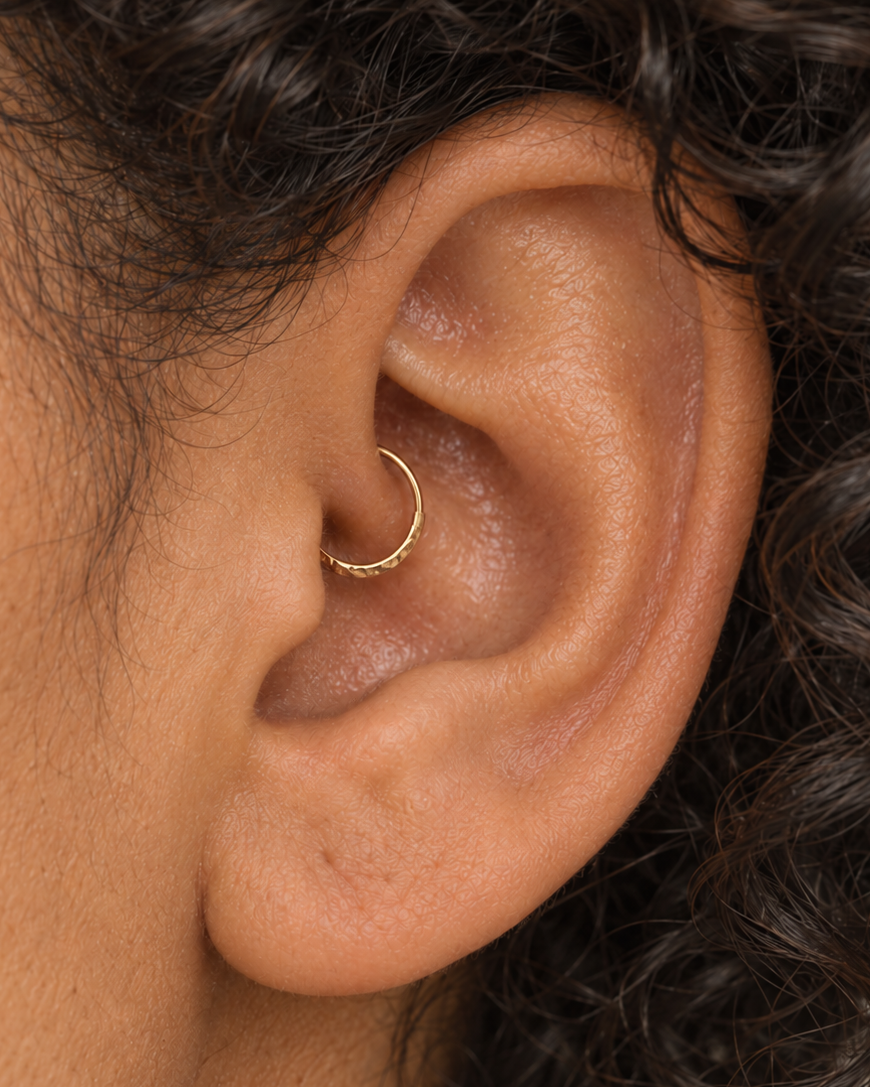 Handmade 14ct solid gold daith hoop with unique hammer marks. Choose 6–10mm, 18G or 20G, in yellow, white or rose gold for your healed inner-ear piercing.