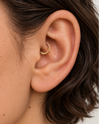 Handmade 14ct solid gold daith hoop with unique hammer marks. Choose 6–10mm, 18G or 20G, in yellow, white or rose gold for your healed inner-ear piercing.