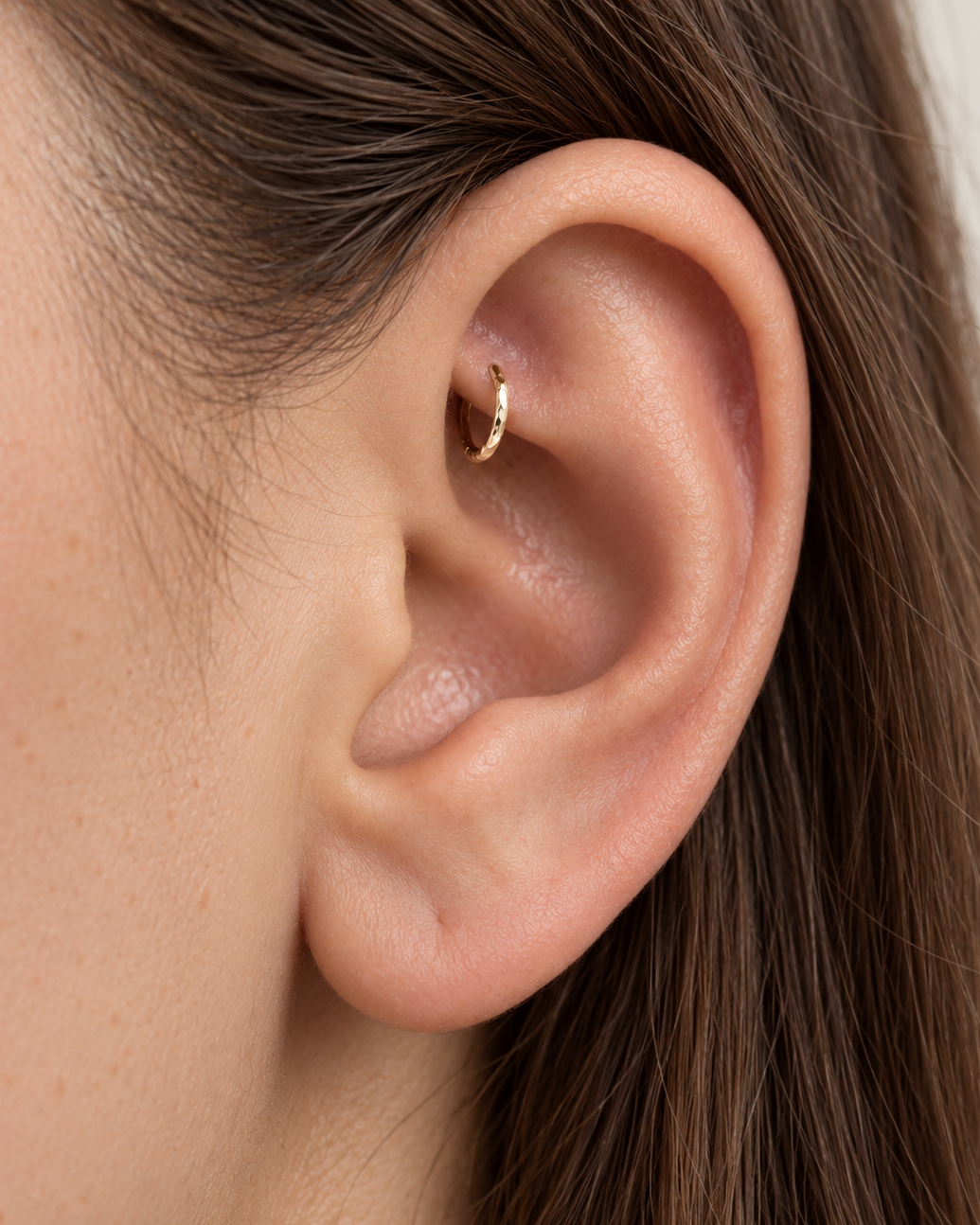 Handmade 14ct solid gold rook hoop with unique hammer marks. Choose 4–8mm, 16G, 18G or 20G, in yellow, white or rose gold for your fully healed rook piercing.