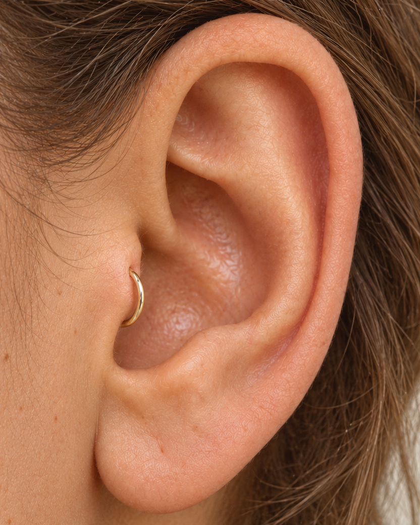 Handmade 14ct solid gold tragus hoop with unique hammer marks. Choose 4–8mm, 18G or 20G, in yellow, white or rose gold for your healed cartilage piercing.