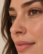 A delicate 14ct solid gold seamless nostril hoop with a hand-hammered outer curve. Made to order in 6–10mm, 18G or 20G, in yellow, white or rose gold.