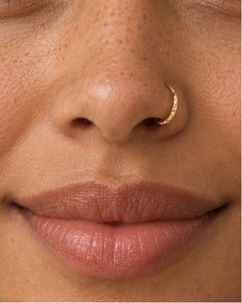 A delicate 14ct solid gold seamless nostril hoop with a hand-hammered outer curve. Made to order in 6–10mm, 18G or 20G, in yellow, white or rose gold.