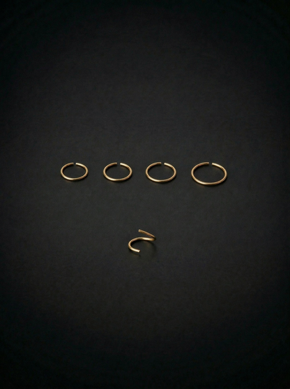 Set of gold earrings on a black background