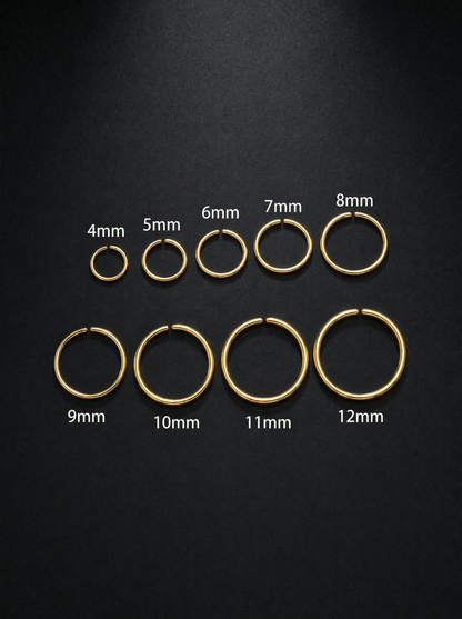 Set of gold hoop earrings in various sizes on a black background