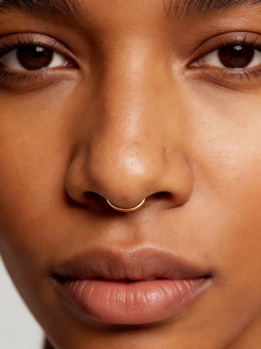 Handcrafted in genuine 14K solid gold, this septum hoop is designed with a refined, minimal feel. Nickel free, hypoallergenic, and lightweight for everyday comfort, it is available in 18G and 20G with inner diameters from 8mm to 12mm, including half sizes.