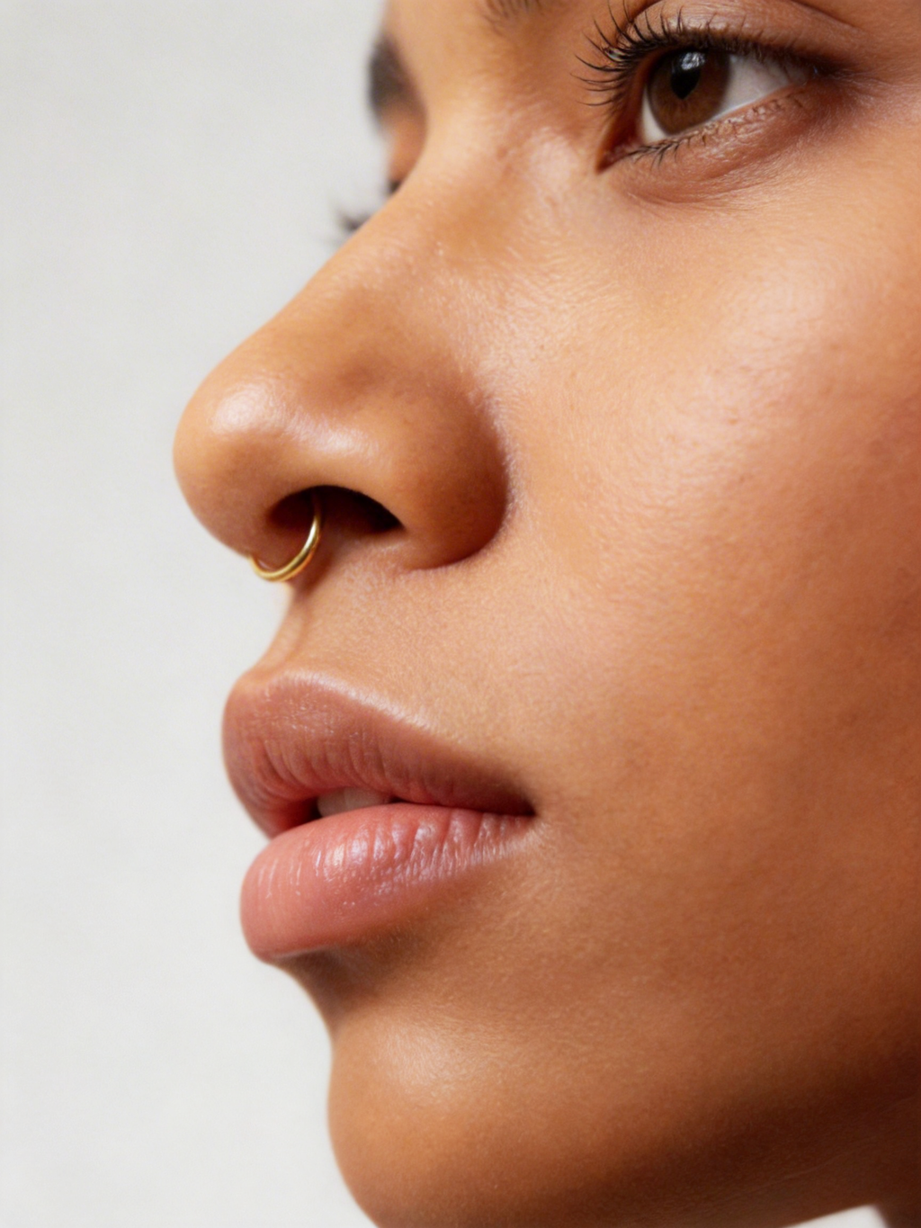 Handcrafted in genuine 14K solid gold, this septum hoop is designed with a refined, minimal feel. Nickel free, hypoallergenic, and lightweight for everyday comfort, it is available in 18G and 20G with inner diameters from 8mm to 12mm, including half sizes.