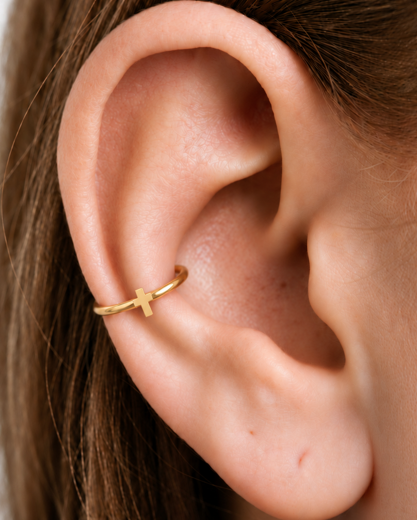 A polished cross gives the hoop a clean symbolic detail without stones, enamel or dangling parts. Made for fully healed conch piercings, it pairs the larger hoop silhouette of a conch ring with a small fixed motif for a more distinctive ear stack. Handmade to order in 14ct solid gold, it fits naturally with clean, symbolic and understated styling rather than reading as a generic plain hoop.