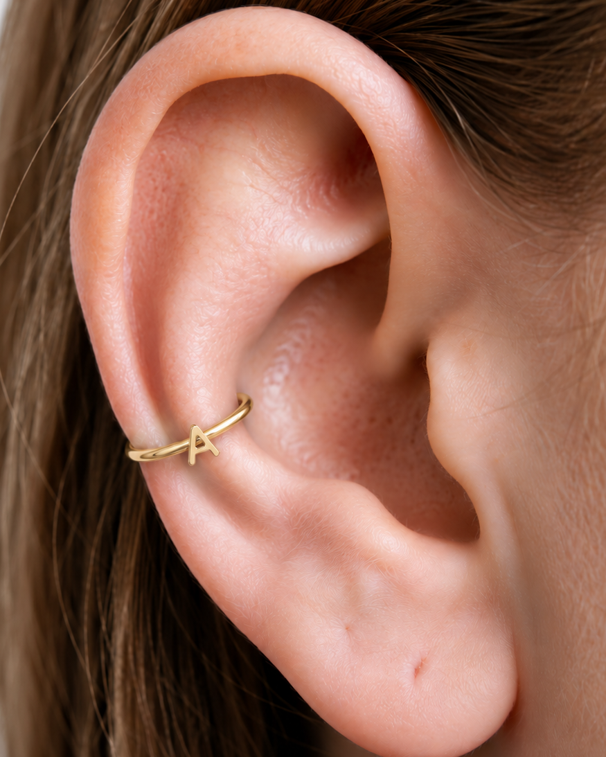 Choose one letter to turn the hoop into a small personalised piece with a clear initial-led focus. Made for fully healed conch piercings, it pairs the larger hoop silhouette of a conch ring with a small fixed motif for a more distinctive ear stack. Handmade to order in 14ct solid gold, it fits naturally with personalised, meaningful and initial-led styling rather than reading as a generic plain hoop.
