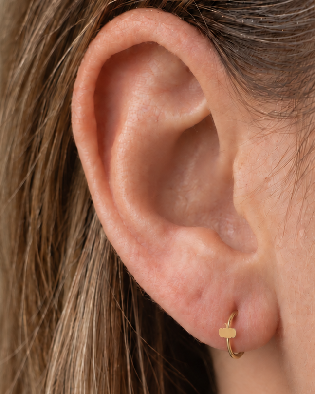 A tiny pumpkin adds an autumn and Halloween note while keeping the piece polished and wearable. Made for fully healed lobe piercings and sold individually, it works easily in first, second or third-lobe stacks. Handmade to order in 14ct solid gold, it fits naturally with autumnal, festive and Halloween-led styling rather than reading as a generic plain hoop.