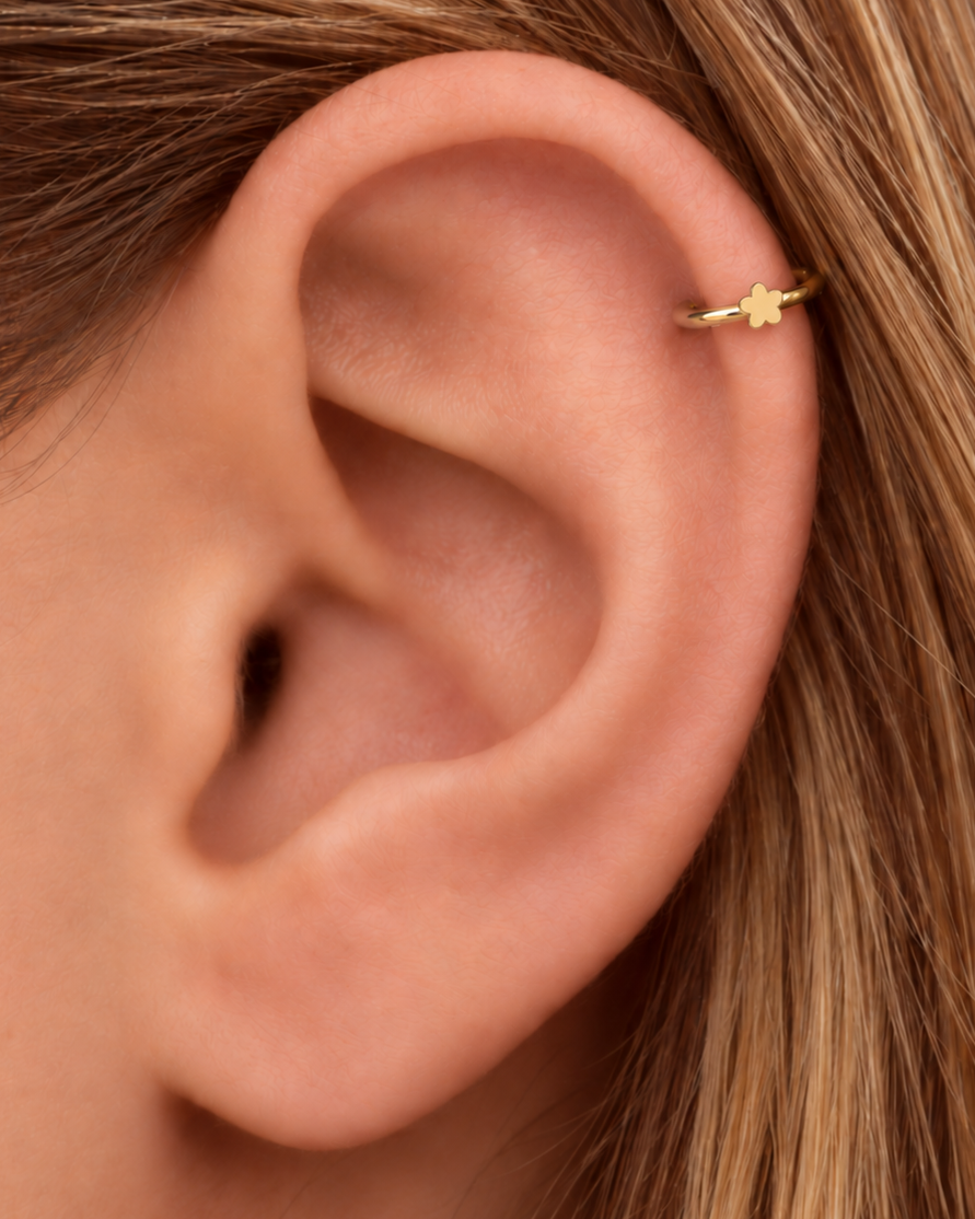 A tiny flower brings a light botanical accent without making the jewellery feel busy. Made for fully healed helix piercings, it keeps the profile compact for an upper-ear stack while leaving the motif clearly visible. Handmade to order in 14ct solid gold, it fits naturally with floral, botanical and nature-inspired styling rather than reading as a generic plain hoop.