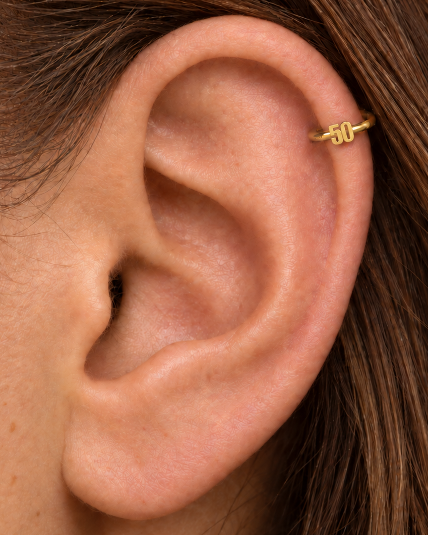 Choose a two-digit number from 10–99 for a more distinctive personalised detail. Made for fully healed helix piercings, it keeps the profile compact for an upper-ear stack while leaving the motif clearly visible. Handmade to order in 14ct solid gold, it fits naturally with personalised, number-led and meaningful styling rather than reading as a generic plain hoop.