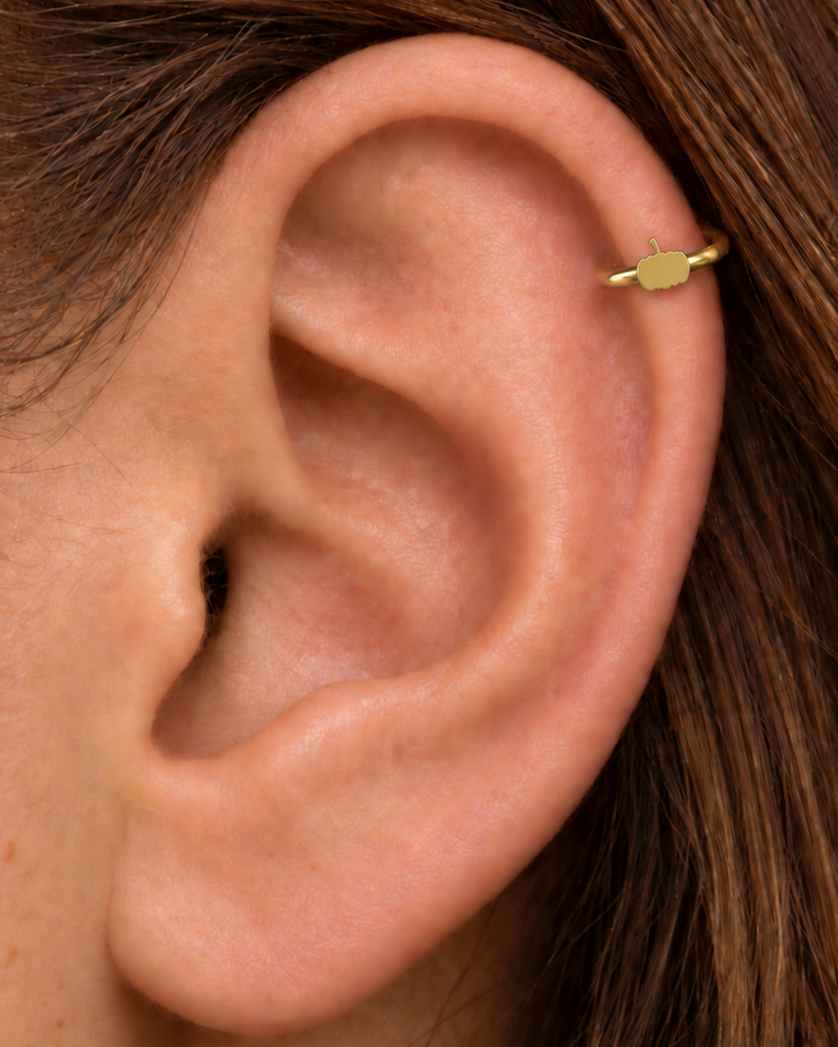 A tiny pumpkin adds an autumn and Halloween note while keeping the piece polished and wearable. Made for fully healed helix piercings, it keeps the profile compact for an upper-ear stack while leaving the motif clearly visible. Handmade to order in 14ct solid gold, it fits naturally with autumnal, festive and Halloween-led styling rather than reading as a generic plain hoop.