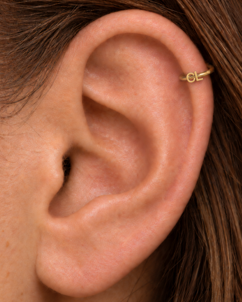 Choose two letters for a compact personalised motif that can represent initials without becoming oversized. Made for fully healed helix piercings, it keeps the profile compact for an upper-ear stack while leaving the motif clearly visible. Handmade to order in 14ct solid gold, it fits naturally with personalised, meaningful and monogram-led styling rather than reading as a generic plain hoop.