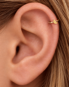 A small crescent moon gives the hoop a subtle celestial character with a polished solid-gold finish. Made for fully healed helix piercings, it keeps the profile compact for an upper-ear stack while leaving the motif clearly visible. Handmade to order in 14ct solid gold, it fits naturally with celestial, lunar and softly symbolic styling rather than reading as a generic plain hoop.