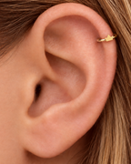 A tiny crown adds a playful statement detail while staying compact enough for everyday styling. Made for fully healed helix piercings, it keeps the profile compact for an upper-ear stack while leaving the motif clearly visible. Handmade to order in 14ct solid gold, it fits naturally with playful, symbolic and statement-led styling rather than reading as a generic plain hoop.