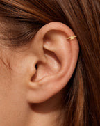 This miniature Christmas tree has a pointed top and three widening tiers, creating a balanced evergreen silhouette. Its smooth polished surface keeps the outline clear, with gently rounded branch corners and a straight lower edge.

Handmade to order in nickel-free 14ct solid gold, this christmas tree helix hoop is available in yellow, white or rose gold. Choose a 5, 6 or 7mm internal diameter and 18G (1.0mm) or 20G (0.8mm). The motif measures approximately 3mm. 