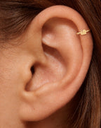 This miniature snail is shown in profile, with two upward-curving feelers, a rounded shell and a small tapered tail. Its smooth, polished surface has no engraved shell spiral or gemstones, keeping the silhouette clear and minimal.

Handmade to order in nickel-free 14ct solid gold, this snail helix hoop is available in yellow, white or rose gold. Choose a 5, 6 or 7mm internal diameter and 18G (1.0mm) or 20G (0.8mm). 